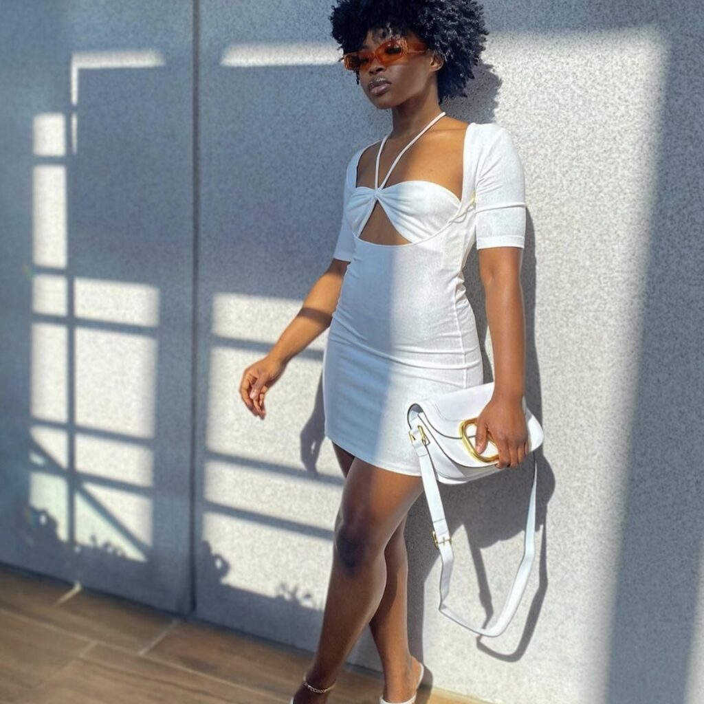 woman in white sundress with white handbag