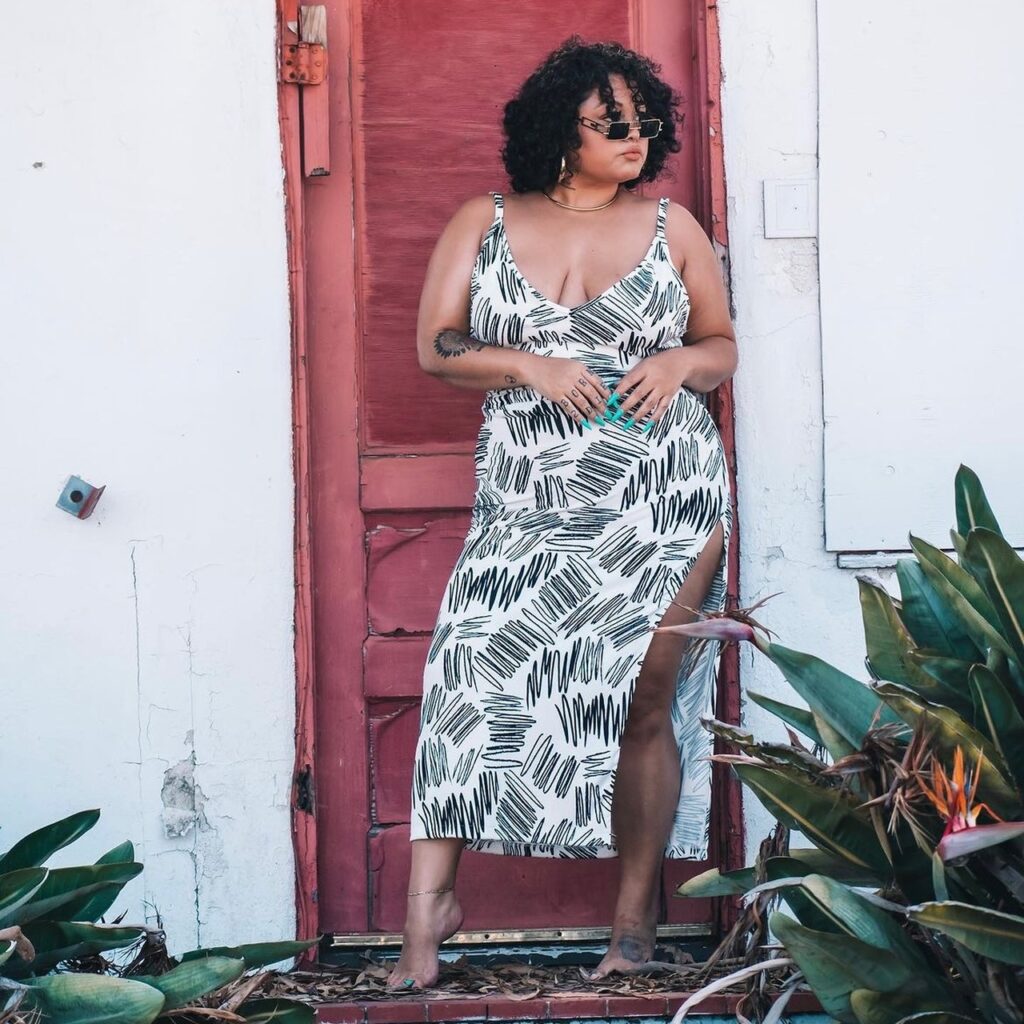 Woman in long sleeveless dress with black and white squiggly print