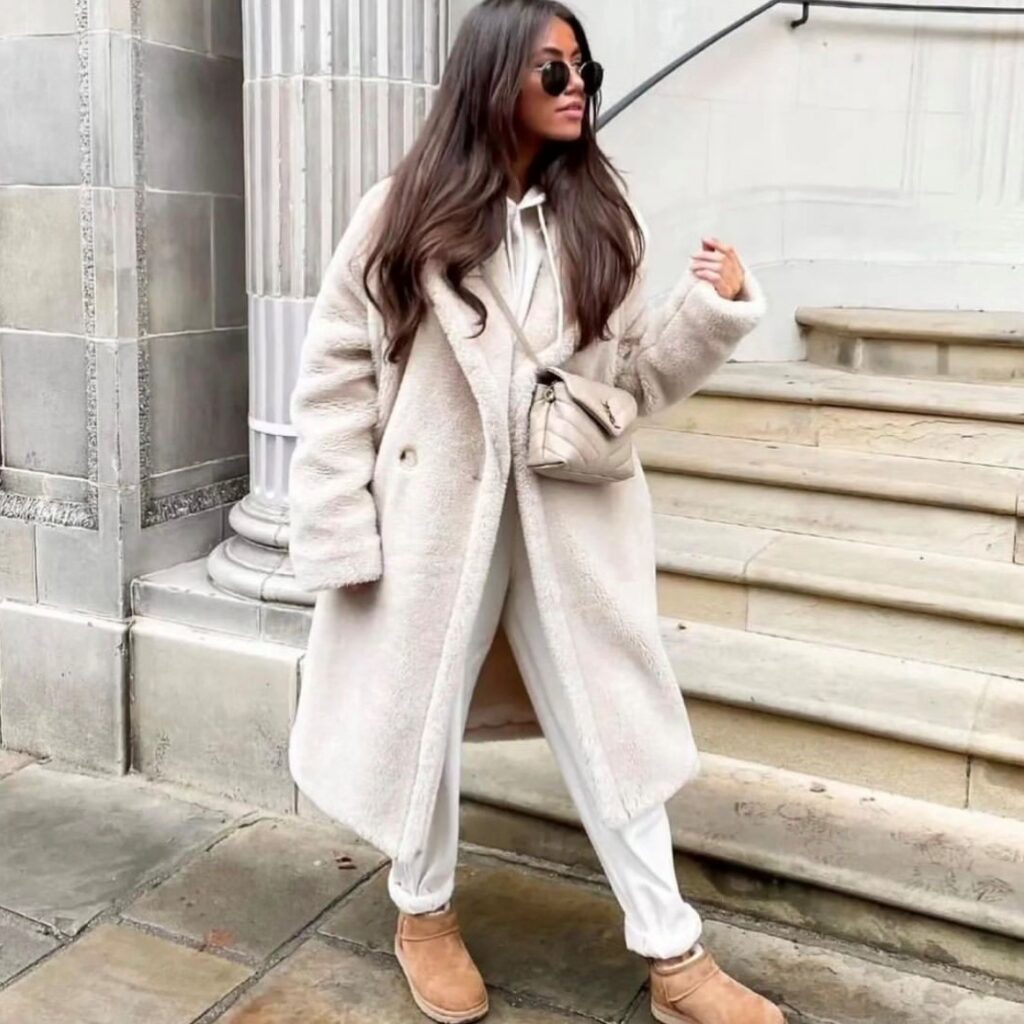 Woman wearing a teddy bear coat over a sweatsuit