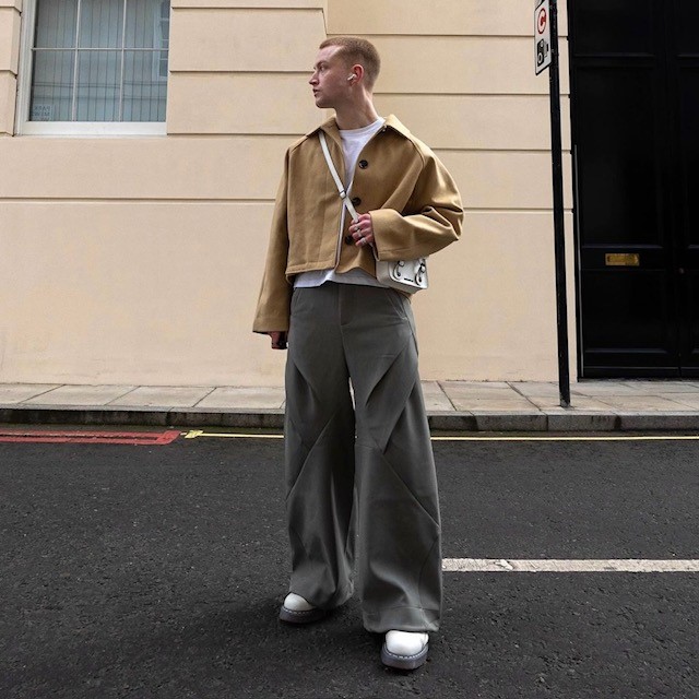 man in gray pants and tan jacket