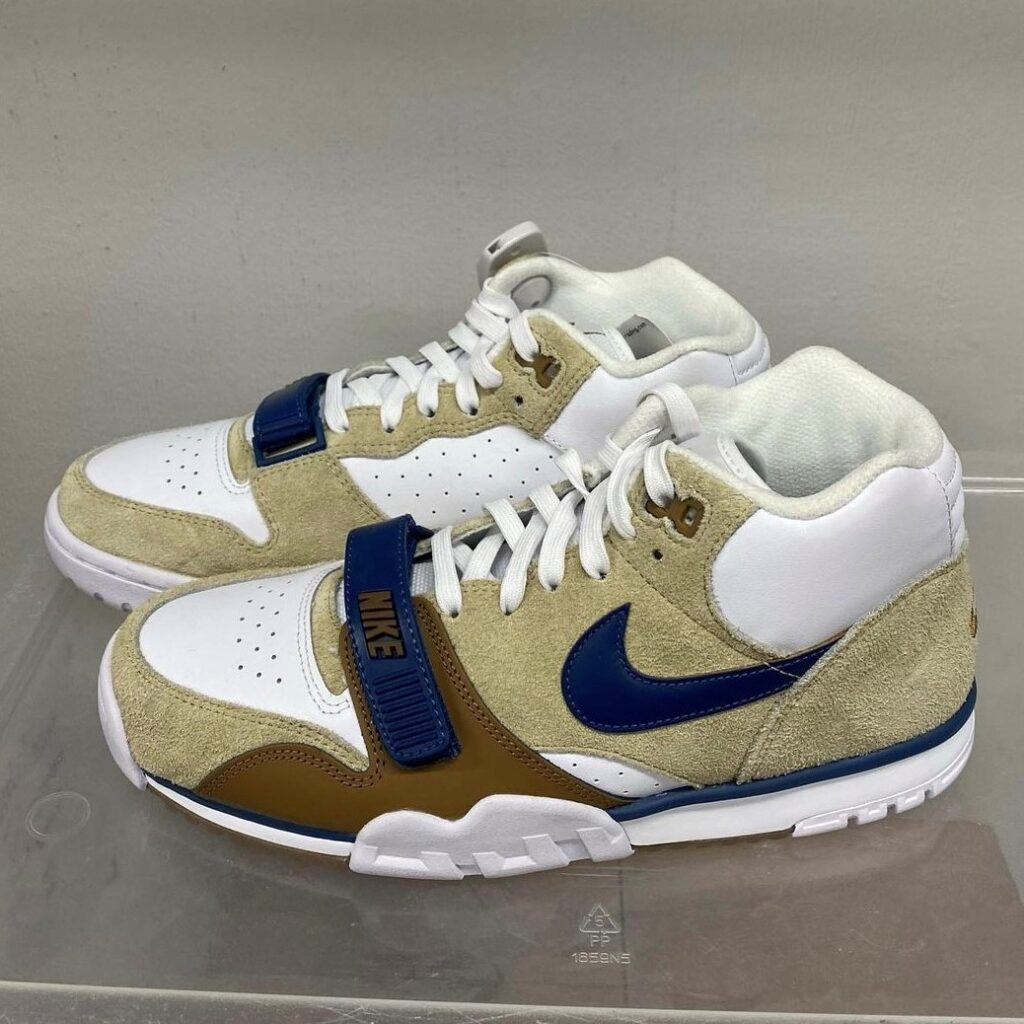 pair of Nike sneakers in tan suede with navy blue swoop