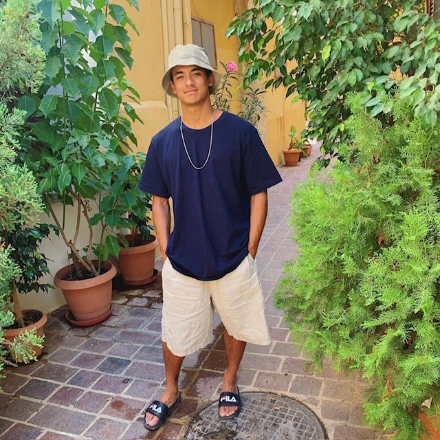 man in oversized blue t-shirt and linen loose fitting shorts