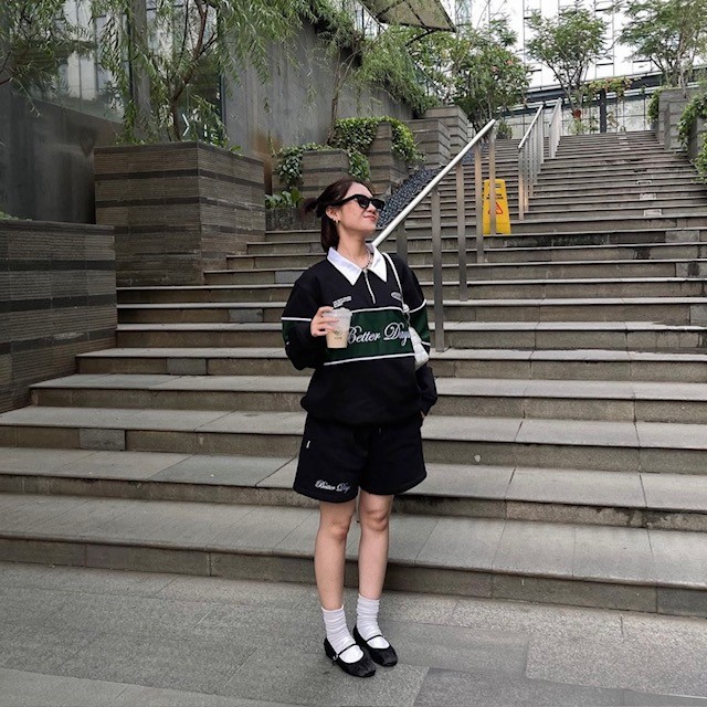 woman with one-stripe version with large black shorts and mary janes