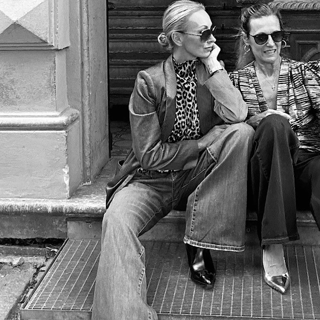 two women sitting on a porch