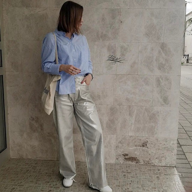 woman in silver pair with blue button-down shirt