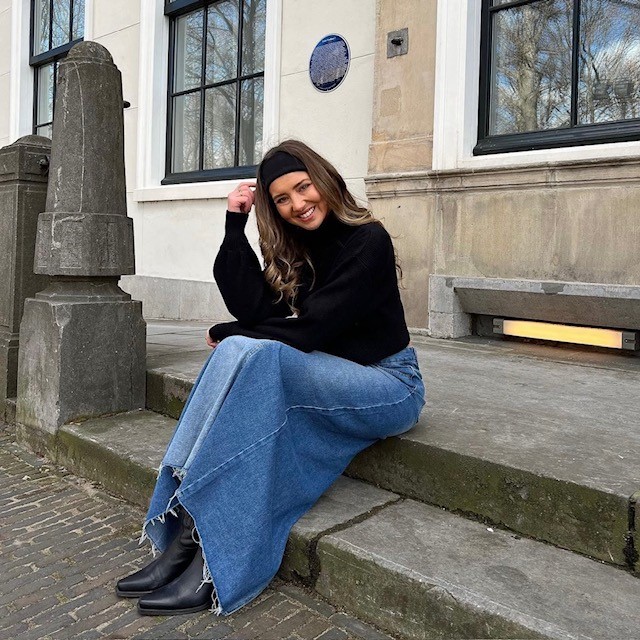 woman wearing one with a black turtleneck and black boots