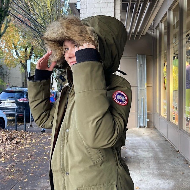 woman wearing a khaki designer jacket