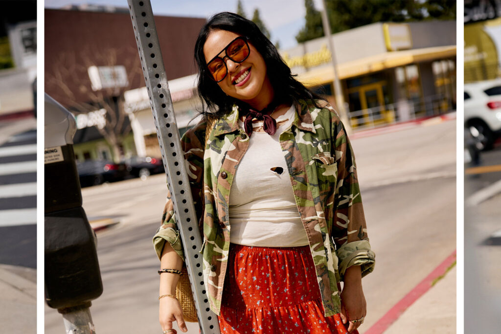 Andrea wearing a camo jacket, white tee and red skirt