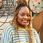 model wearing a striped sweater smiling at the camera