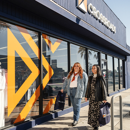 photo of two models in front of crossroads store