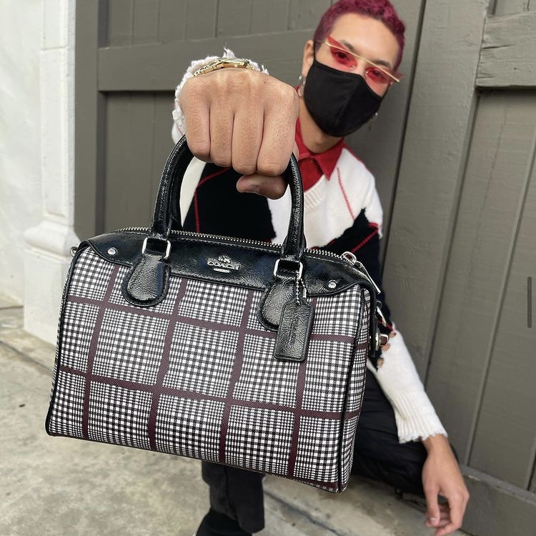 Employee holding designer bag