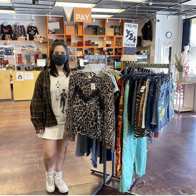 Photo of employee next to sales rack