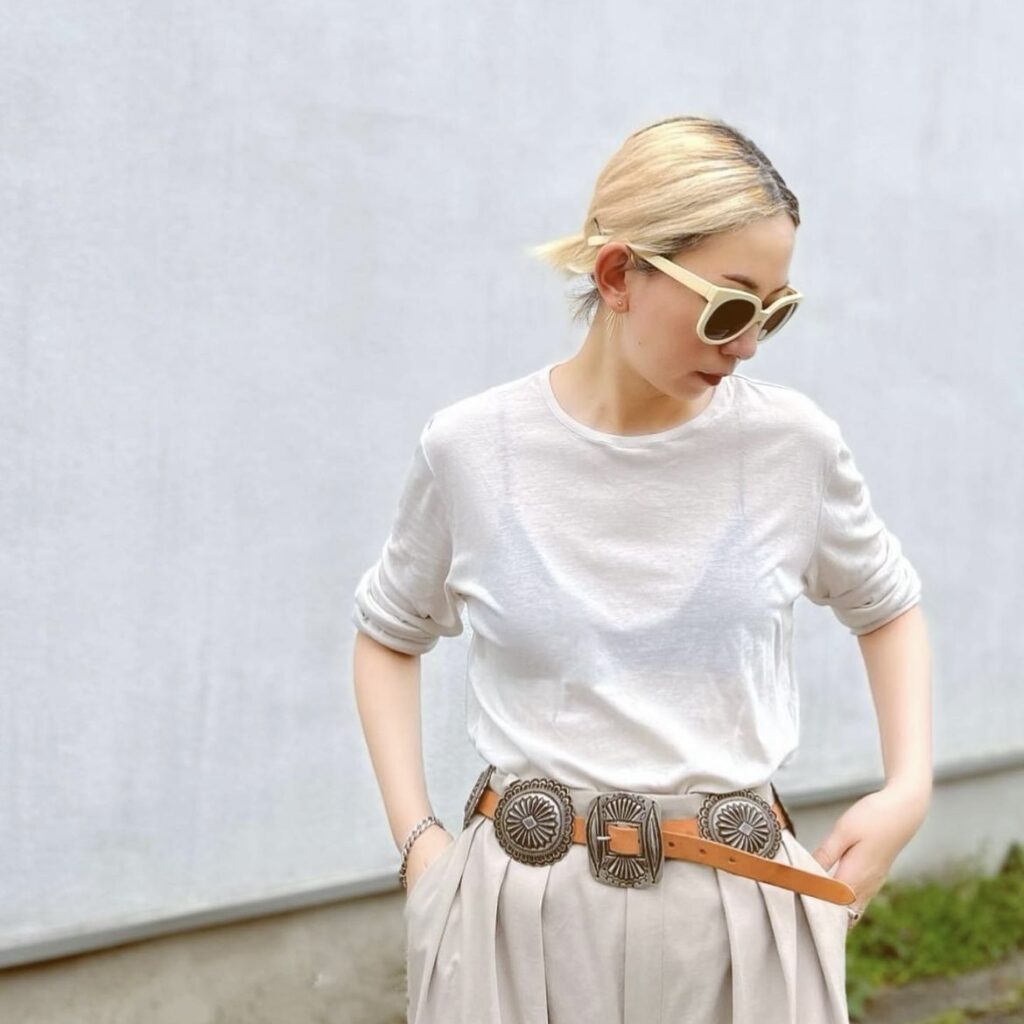 photo of person with gauzy white sweater and beige trousers