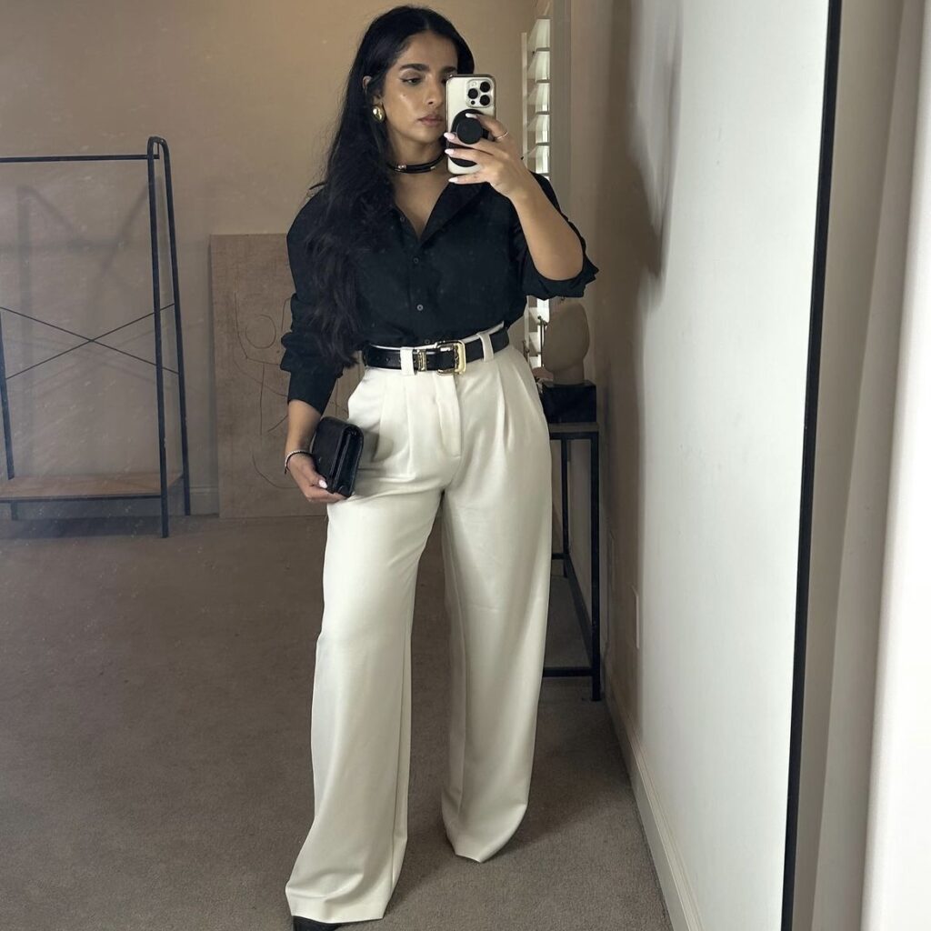 photo of person wearing cream-colored pants and a black blouse