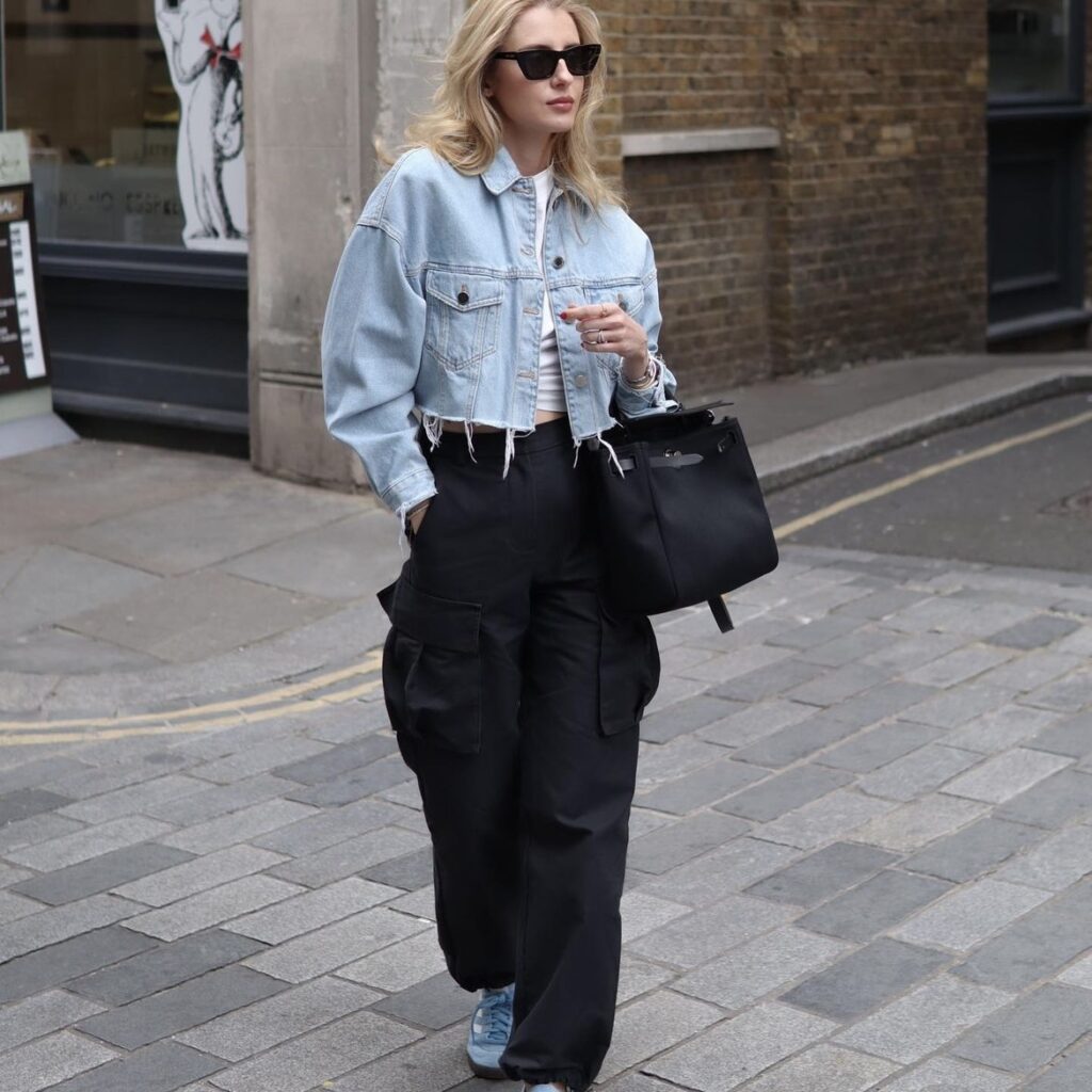 photo of person in black pants and cropped denim jacket