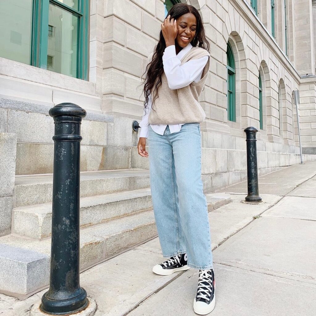 photo of person in jeans and sneakers and long sleeve top