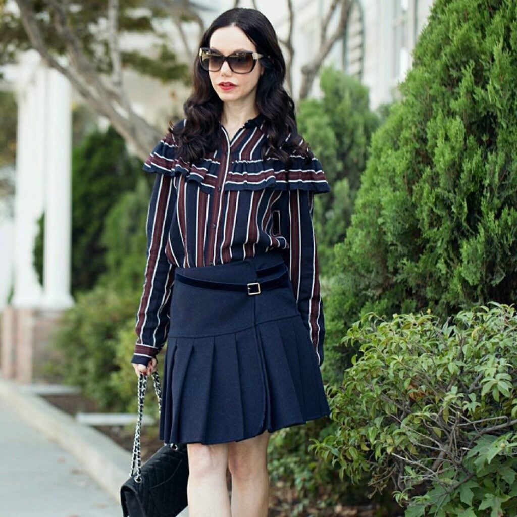 photo of woman with blouse and pleated skirt