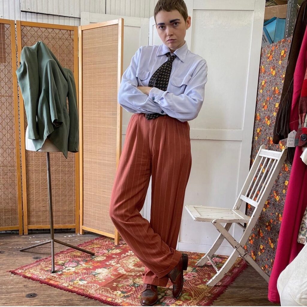 person dressed in orange pinstripe pants and shirt with tie