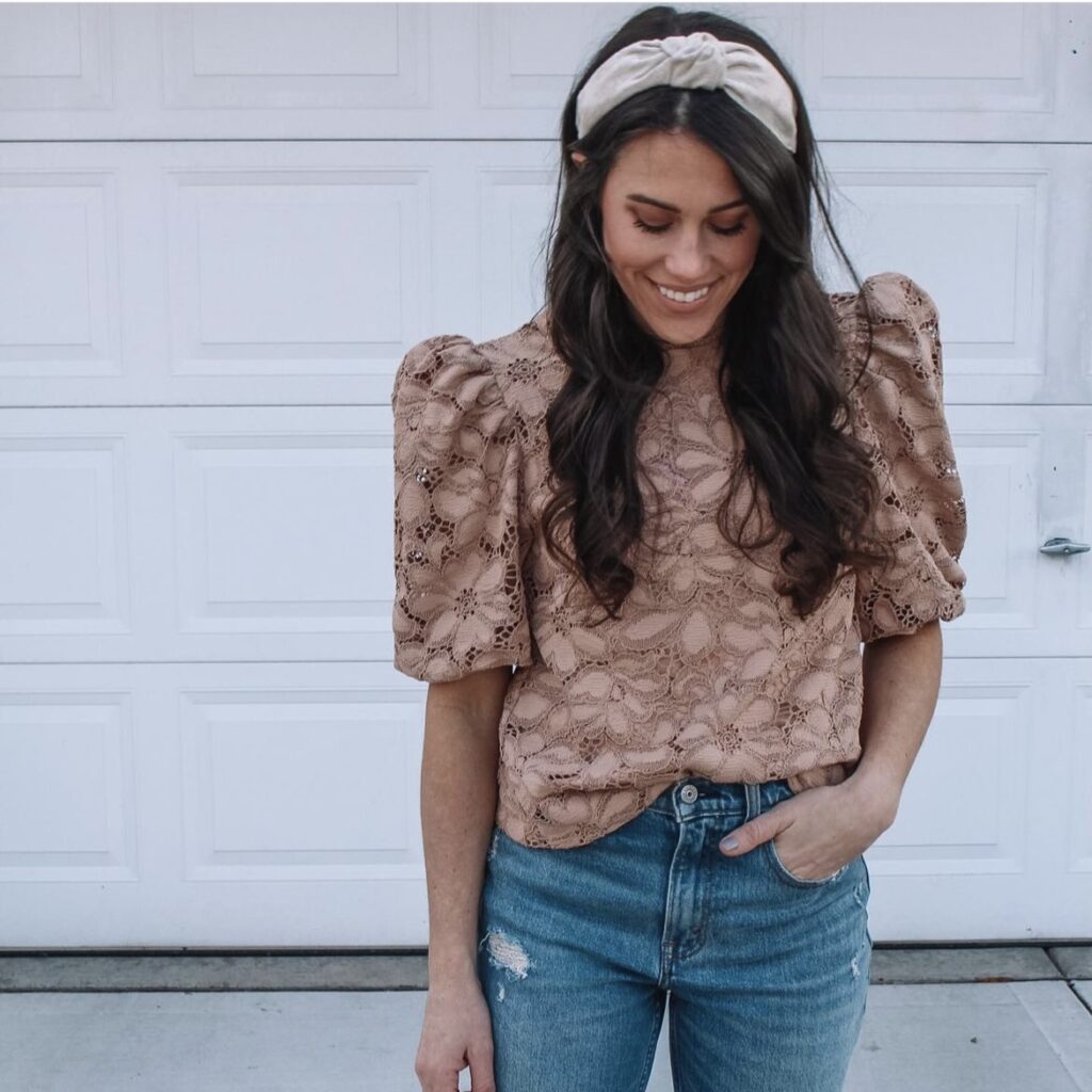 woman wearing a mocha-colored top with jeans and a cream-colored headband