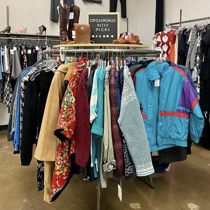 A rack of vintage clothing in a store where you can sell old clothes for cash or store credit