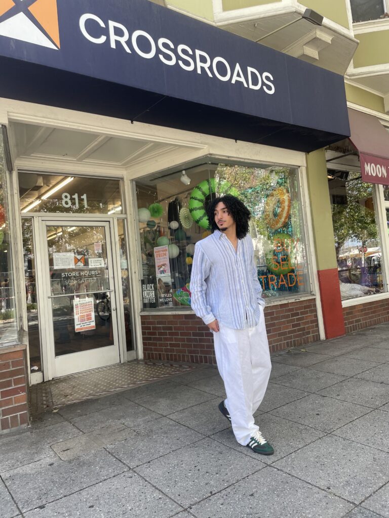 man in summer trends of linen button-up and pants with Adidas sneakers