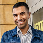 model wearing a striped collard shirt and a denim jacket